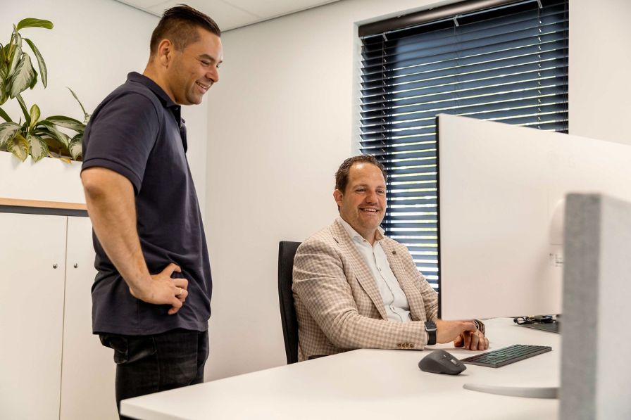 Roy en Herwin in overleg bij de werkplek 